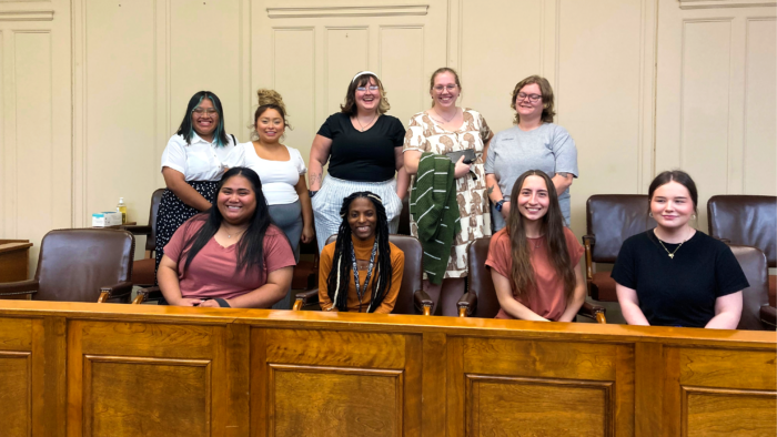 九十一年&M-Commerce students sit in two rows within the jury box of a courtroom.